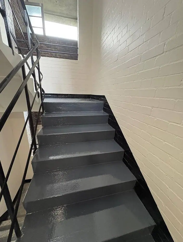Stair and landing with repainted steel balustrade
