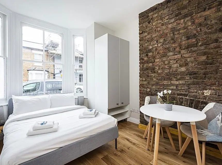 A finished living area with exposed brickwork