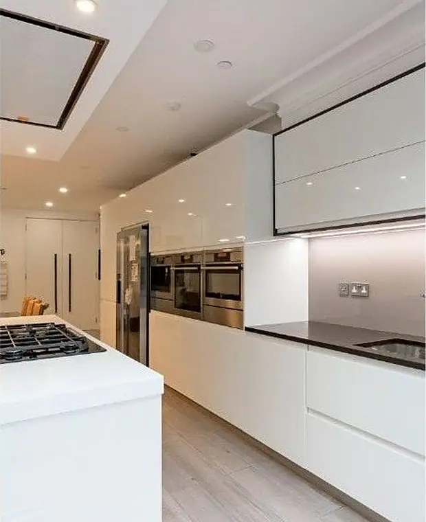 Fitted kitchen with island and stone worktop