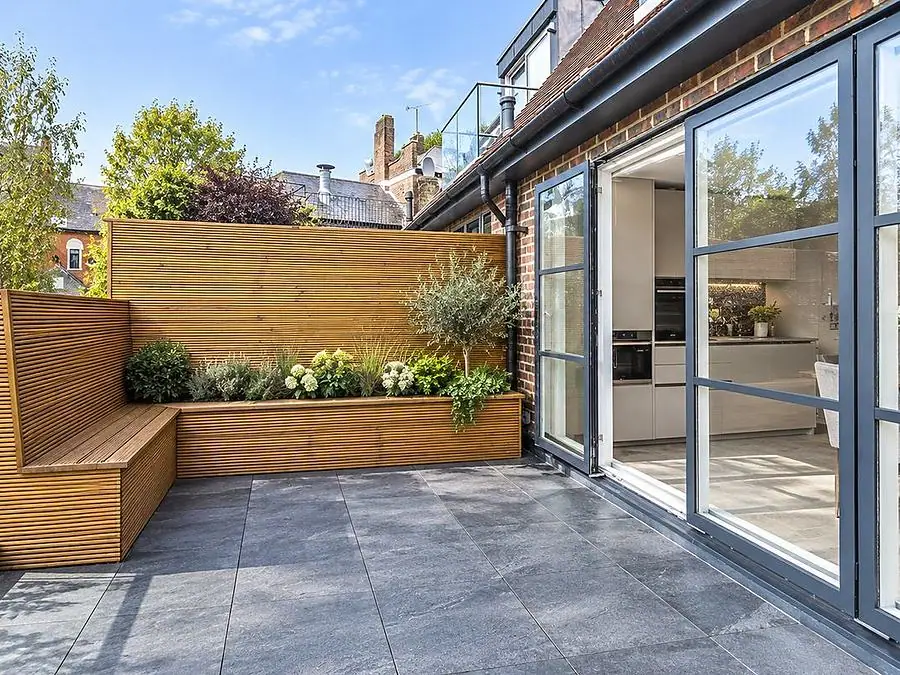 A roof terrace with planters and bi-fold doors, by Ogival in Shepherd&rsquo;s Bush